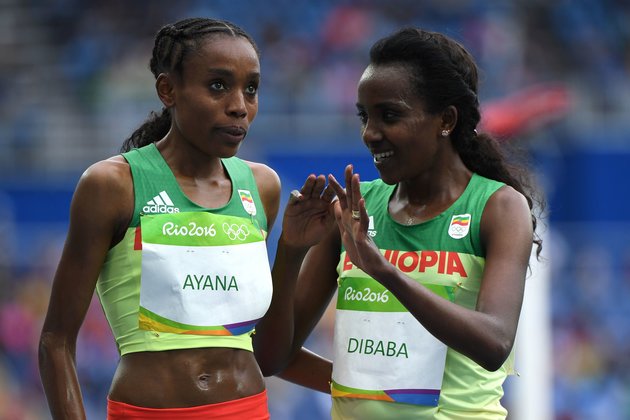 Ethiopia's Almaz Ayana (L) celebrates with third placed Ethiopia's Tirunesh Dibaba after she won the Women's 10,000m during the athletics event at the Rio 2016 Olympic Games at the Olympic Stadium in Rio de Janeiro on August 12, 2016. / AFP / OLIVIER MORIN (Photo credit should read OLIVIER MORIN/AFP/Getty Images)