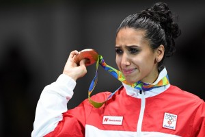 Tunisia's bronze medallist Ines Boubakri cries on the podium during the medal ceremony for the women's individual foil fencing event of the Rio 2016 Olympic Games at the Carioca Arena 3 in Rio de Janeiro on August 10, 2016. / AFP PHOTO / Kirill KUDRYAVTSEV