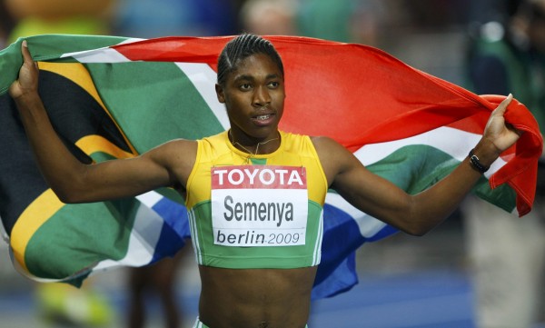Caster Semenya of South Africa holds her national flag as she celebrate after the women's 800 metres final during the world athletics championships at the Olympic stadium in Berlin August 19 , 2009. REUTERS/Phil Noble (GERMANY)