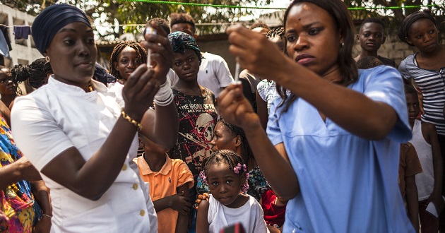 Health agents are pictured during the first day of the yellow fever vaccination campaign in Kinshasa, on August 17, 2016.