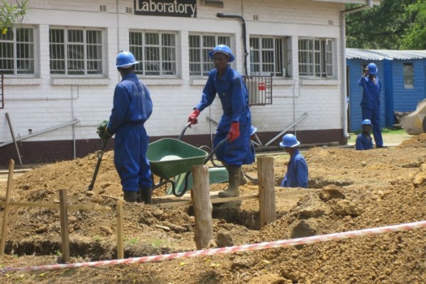Workers at a construction site for a health facility supported by the UNDP/Global Fund