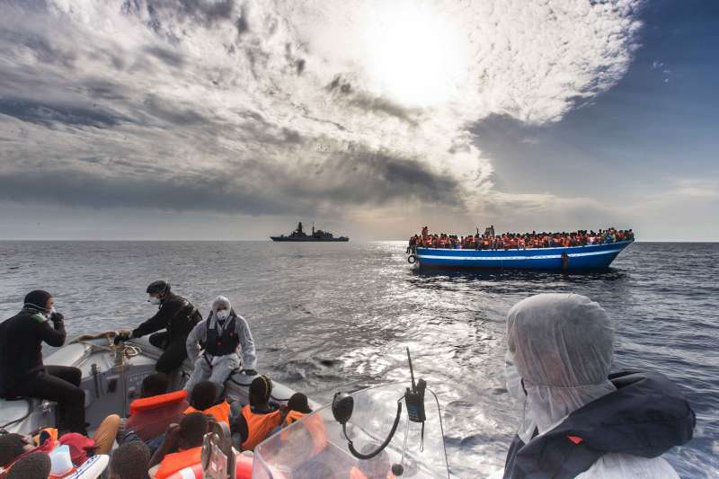 Italian Navy rescues boat filled with refugees and migrants in the Mediterranean last year