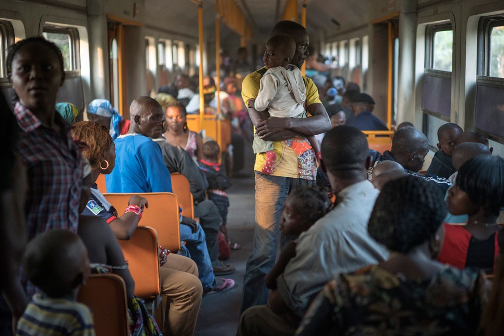 Angolan refugees, some of whom had been living in exile in the Democratic Republic of Congo for up to 40 years, journey back to their homeland by train from Kinshasa. Over the course of 2014, 126,800 refugees returned to their country of origin. This figure was the lowest level of refugee returns since 1983. © UNHCR/B.Sokol A former refugee child is held by his father on a train headed from Kinshasa, DRC toward Angola on 19 August, 2014. Nearly 500 former refugees departed Kinshasa to return to Angola on 19 August, 2014. The journey, made on train and bus, took approximately 36 hours to reach the Angolan border. UNHCR is coordinating the return of nearly 30,000 former refugees to Angola. UNHCR / B. Sokol / August 2014