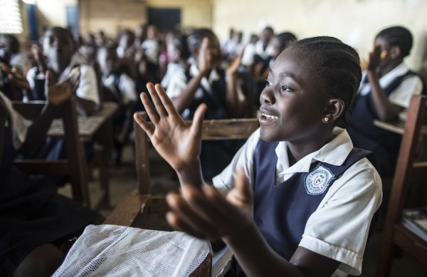 A girl at the UNICEF-supported Monrovia Demonstration School in Liberia during a class sing-along on the first day of the new academic year. © UNICEF