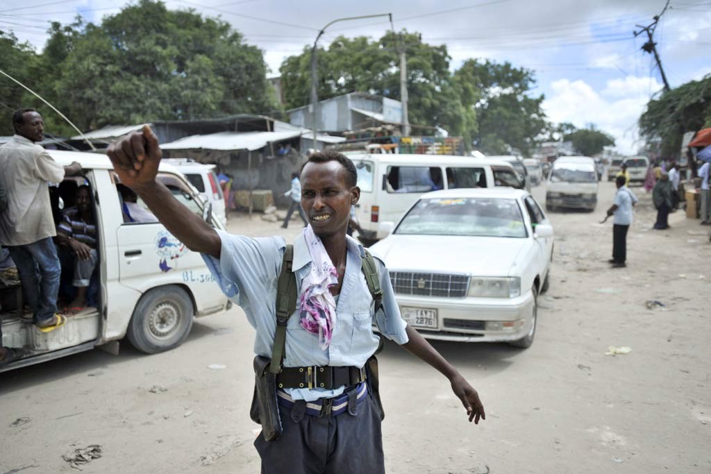 A policeman directs traffic at a checkpoint in downtown Mogadishu, Somalia. UN Photo/Tobin Jones 
