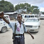 A policeman directs traffic at a checkpoint in downtown Mogadishu, Somalia. UN Photo/Tobin Jones