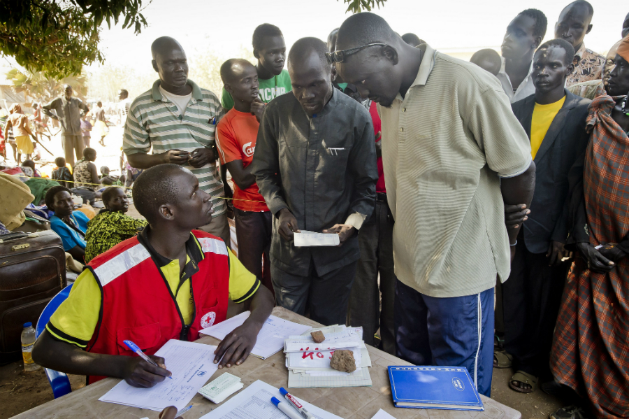A man and his family register as refugees in Uganda. Photo credit: UNHCR/F. Noy
