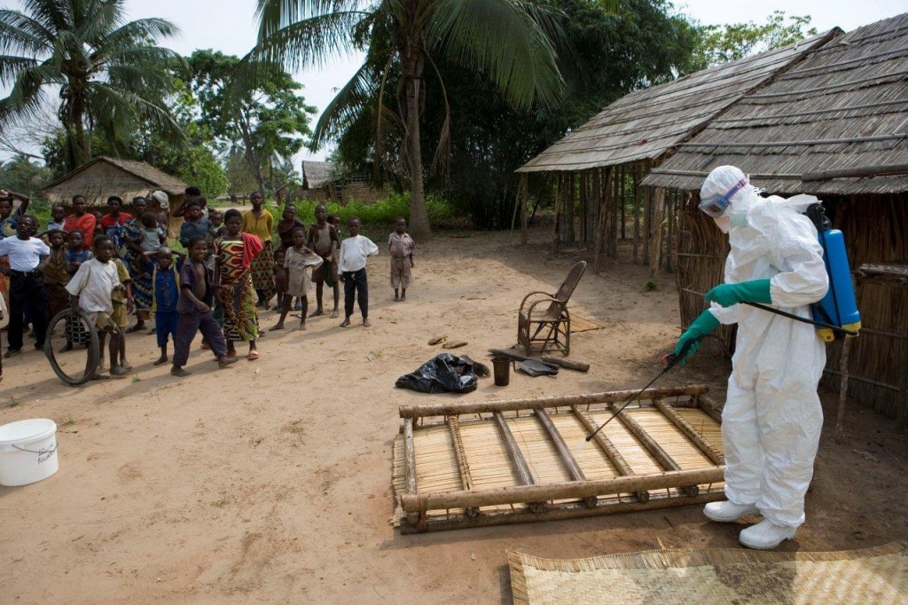 Healthcare worker disinfects areas where cases of deaths from Ebola have been reported. Credit: WHO 