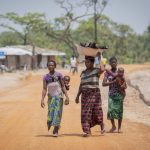 Refugee women from the Democratic Republic of the Congo walk towards the market in Mantapala Settlement, Zambia UNHCR Will Swanson